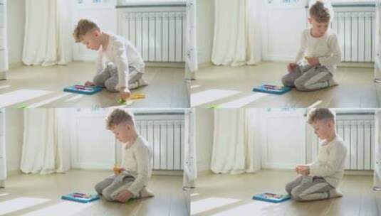 小男孩在托儿所的地板上玩教育玩具高清在线视频素材下载