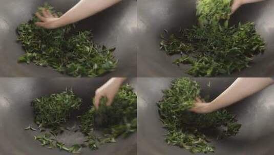 茶缸中用手翻炒绿色茶叶实拍视频高清在线视频素材下载