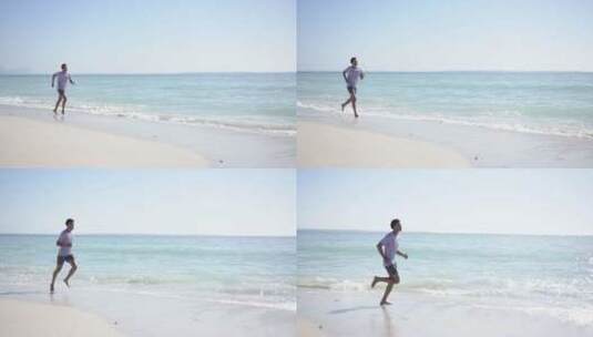 一个年轻的混血儿沿着阳光明媚的海滩慢跑，高清在线视频素材下载