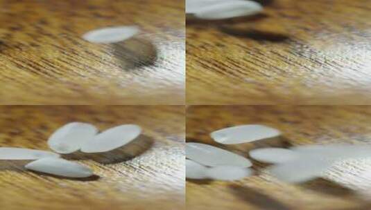 2K竖屏大米粒掉落在木桌板上高清在线视频素材下载