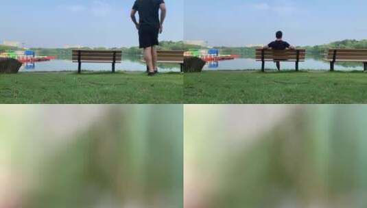 中年男子坐在湖边的长板凳上高清在线视频素材下载
