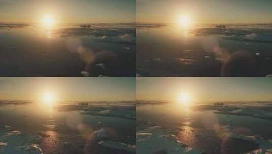 南极洲橙色日落太阳眩光史诗鸟瞰无人机飞行高清在线视频素材下载
