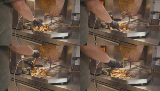快餐店里，厨师在旋转的唾液上切烤肉串肉，高清在线视频素材下载