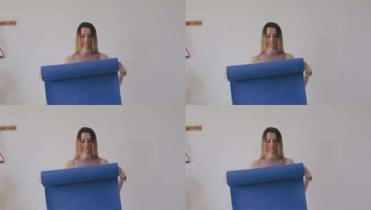 女人在卷瑜伽垫高清在线视频素材下载