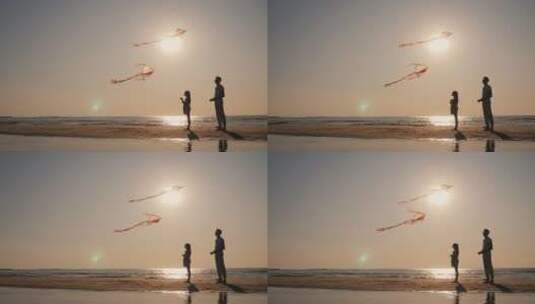 爸爸和女儿在海滩上玩风筝高清在线视频素材下载