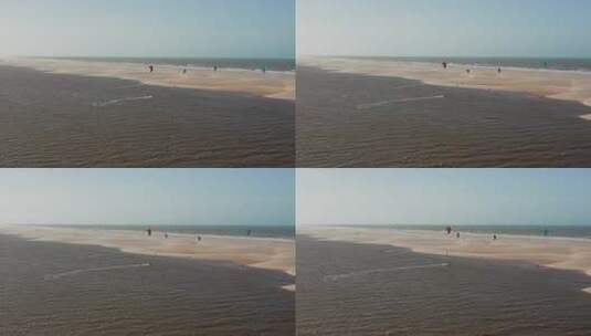 航拍人们在海边沙滩上风筝冲浪高清在线视频素材下载