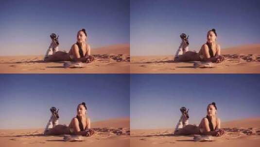 穿着比基尼和靴子躺在沙漠沙滩上的年轻女子高清在线视频素材下载