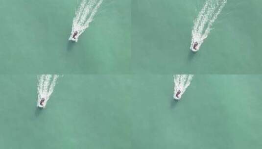 航拍俯瞰威海国际海水浴场海面航行快艇高清在线视频素材下载