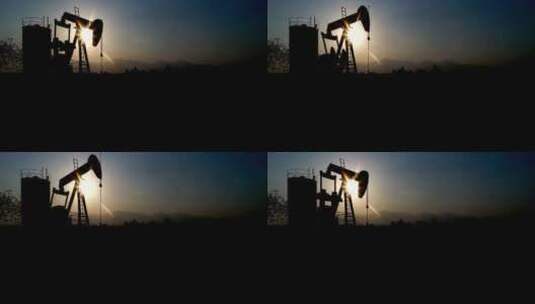 夕阳下的钻井机器器剪影高清在线视频素材下载