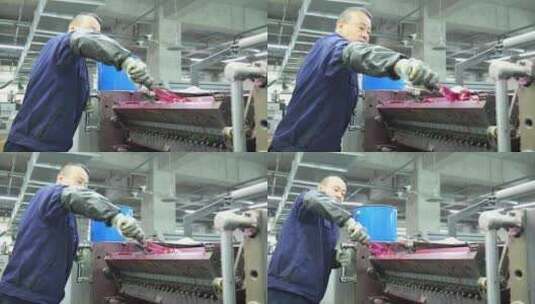 印刷厂男工人在给滚轮抹油膜高清在线视频素材下载