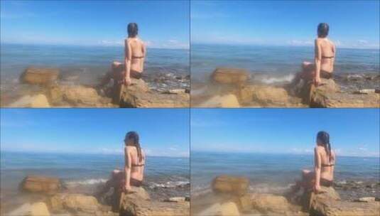 女孩坐海岸边看风景高清在线视频素材下载