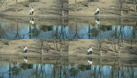 初春在公园河边散步的中国母女高清在线视频素材下载