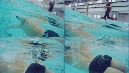 教练记录游泳运动员的游泳状态高清在线视频素材下载