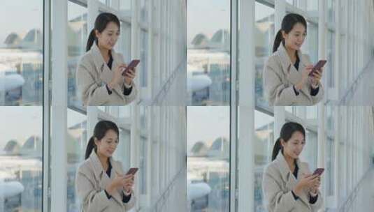 女商人在机场用手机高清在线视频素材下载