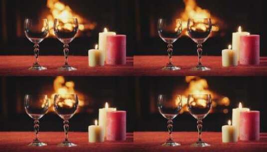 酒杯和蜡烛放在壁炉前的桌面上高清在线视频素材下载