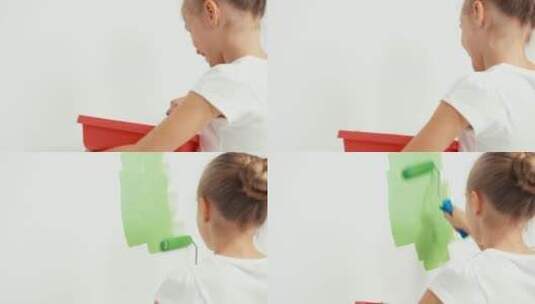 女孩拿着绿色的油漆刷墙高清在线视频素材下载