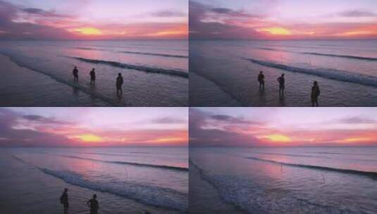 夕阳下海滩边三人背影高清在线视频素材下载