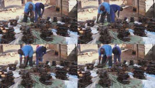两个非洲黑人鱼烘干和包装场所高清在线视频素材下载