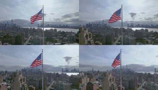 空中慢动作拍摄美国国旗在风中放弃，背景是纽约市。高清在线视频素材下载