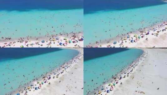 人们在清澈的热带绿松石浅蓝色大海的白色沙滩上度假游泳高清在线视频素材下载