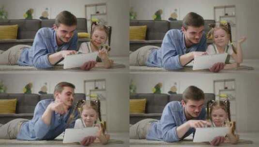 全神贯注的父亲和小女孩专注于家中的平板电高清在线视频素材下载