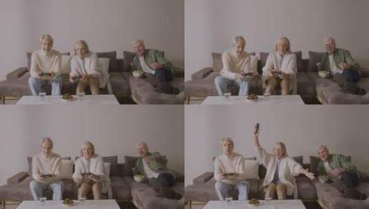 沙发上玩游戏的快乐老年妇女高清在线视频素材下载