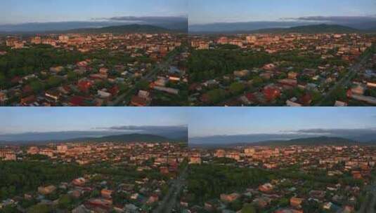 黄昏时分背景中有许多房屋和山脉的城镇，蓝天和云彩高清在线视频素材下载