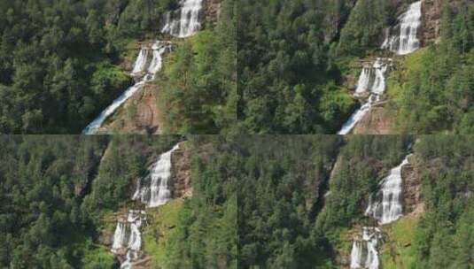 一个美丽的瀑布从森林覆盖的山脉上瀑布。高清在线视频素材下载