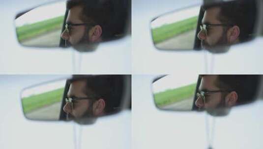 从反光镜中看正在开车的男人高清在线视频素材下载