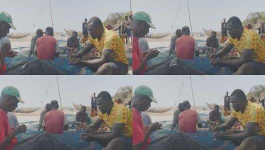 渔民在海滩坐着割渔网高清在线视频素材下载