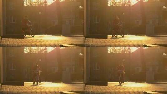 小女孩在夕阳中骑自行车高清在线视频素材下载