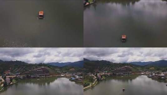 无人机倾斜向上拍摄班拉克被山脉包围的拉克泰国村旁边的一个湖高清在线视频素材下载