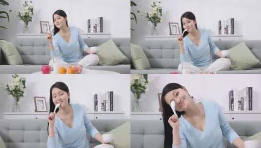 一个年轻女性在家吃早餐高清在线视频素材下载