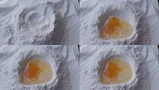 将鸡蛋打入准备好的面粉中高清在线视频素材下载