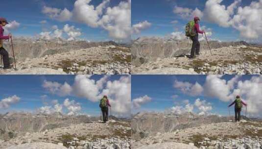 背包客在山景徒步旅行。白云石阿尔卑斯山的高清在线视频素材下载