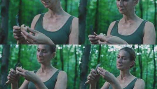 女孩在森林里用刀切割蘑菇高清在线视频素材下载