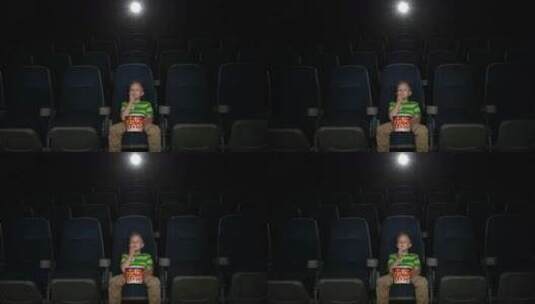 小男孩独自在电影院看电影高清在线视频素材下载