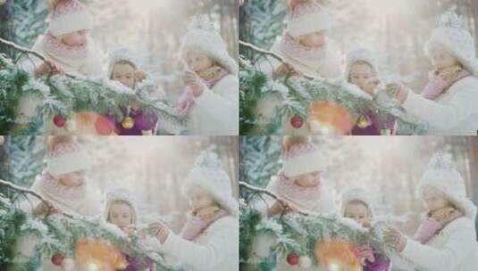 妈妈带着女儿装饰圣诞树高清在线视频素材下载