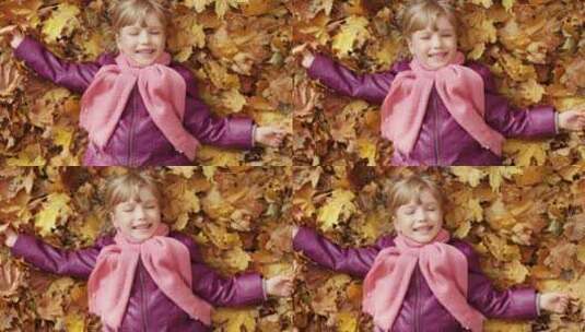 躺在枫叶上的小女孩微笑这挥手高清在线视频素材下载