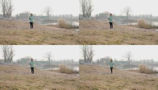 冬季在公园湖边游玩的中国女孩高清在线视频素材下载