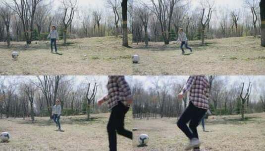 初春在公园草坪上踢足球的中国母女高清在线视频素材下载