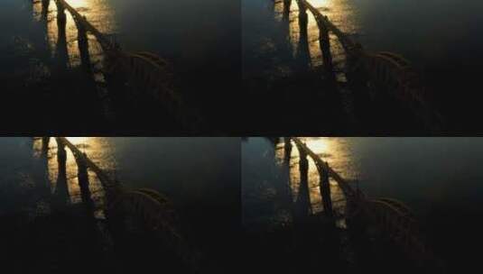 从空中俯瞰一座桥和夕阳中的城市高清在线视频素材下载