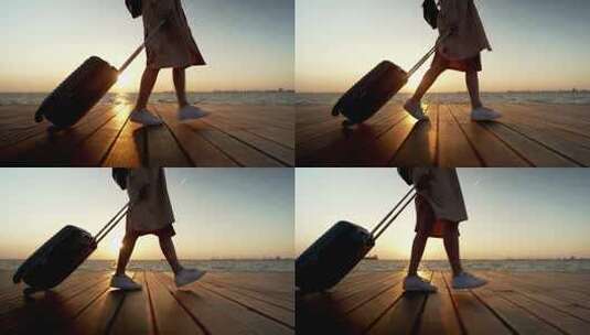 夕阳下以为女性手拉行李箱出门远行旅游高清在线视频素材下载
