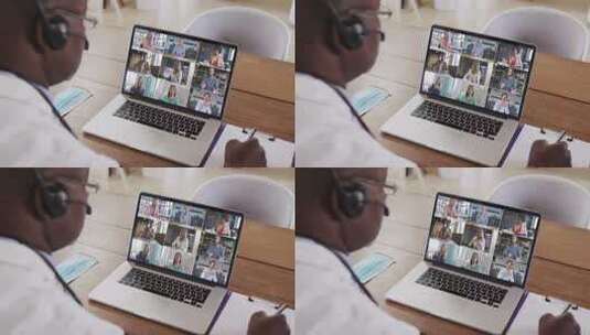 非裔美国男医生在笔记本电脑上进行视频会议时做笔记高清在线视频素材下载