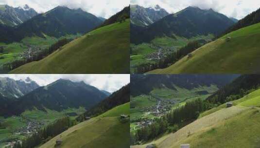 无人机鸟瞰草地，背景是高山，靠近韦尔戈尔——一个小维拉格高清在线视频素材下载