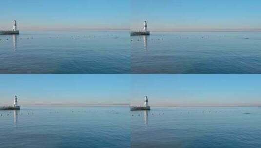 清晨平静的蓝色海面与灯塔高清在线视频素材下载