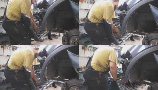 汽车维修专业维修人员从汽车上拆卸前保险杠高清在线视频素材下载