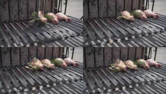 唐把生鸡腿和迷迭香放在烧烤架上高清在线视频素材下载