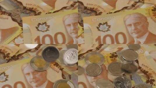 落在100美元聚合物纸币上的加拿大硬币，上面有罗伯特·博登的肖像。高清在线视频素材下载