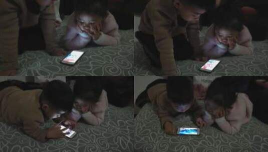 少年儿童在昏暗的环境看手机高清在线视频素材下载